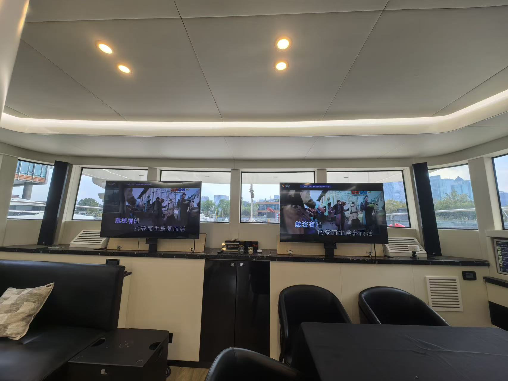 Salon entertainment area with TVs of Mazarin 55 sailing catamaran