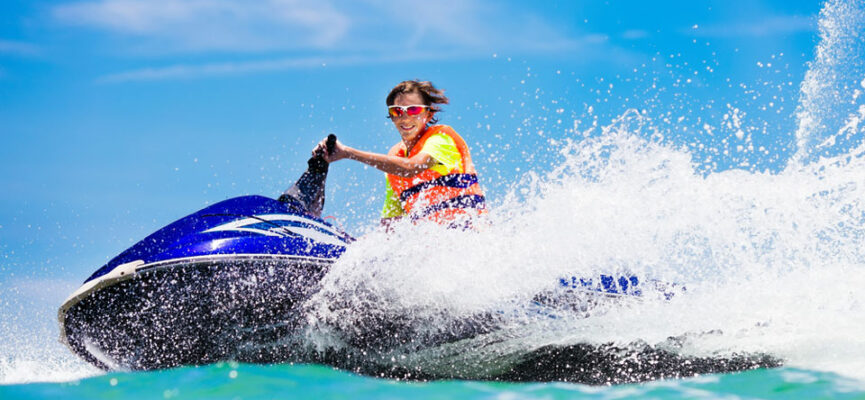 Person riding a jet ski on blue water