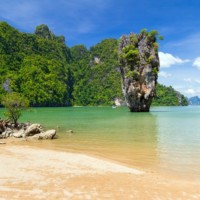 Limestone islands rising from emerald water in Phang Nga Bay
