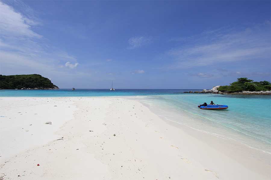 Clear blue water with gentle waves, ideal for swimming