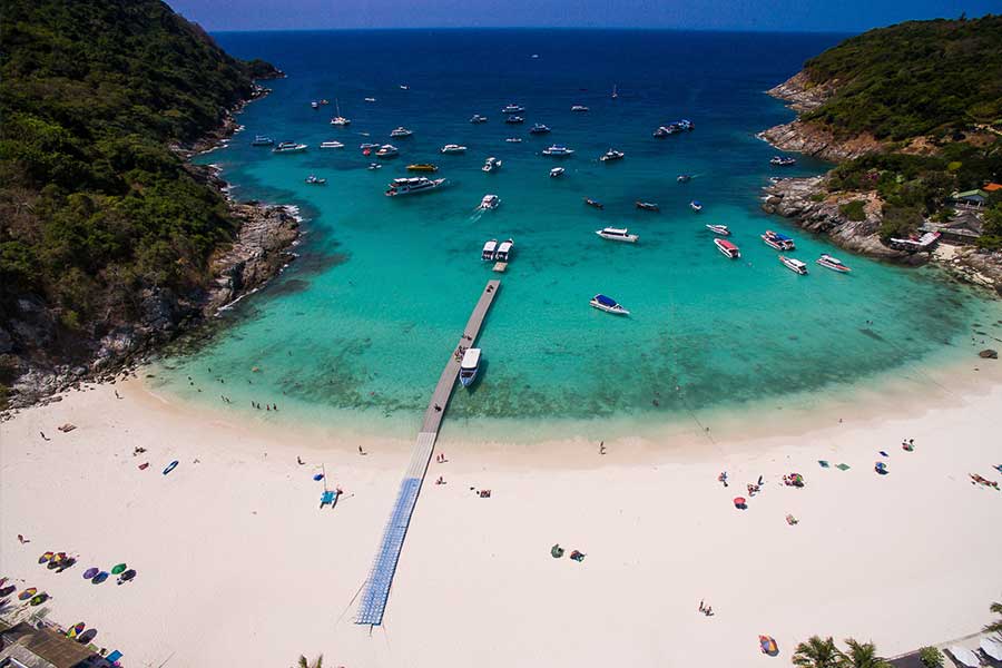 Anchored boats in a sheltered bay at Racha Islands