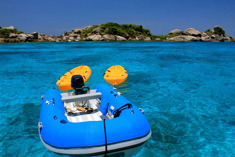 Boats anchored off a white-sand beach in the Similan Islands